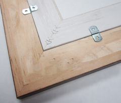 Offset clips are used to hold the linen liner in the picture frame