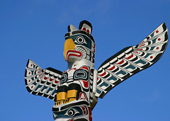 A beautifully painted totem pole in Vancouver, British Columbia