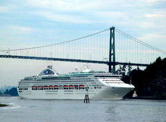A cruise ship passing under the Lions Gate Bridge in Vancouver, British Columbia
