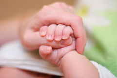 A child's grip on their mother's hand